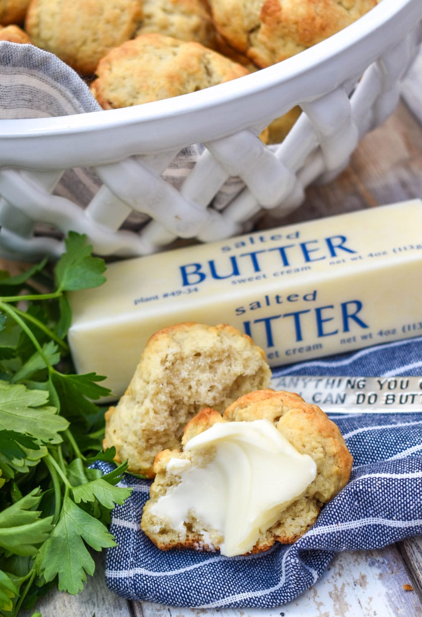 a buttered drop biscuits on a blue and white striped cloth napkin