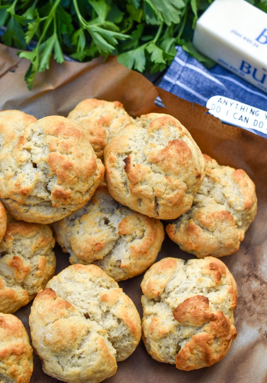 a pile of easy drop biscuits on a parchment lined baking sheet