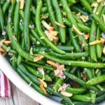 easy green bean almondine in a white serving dish