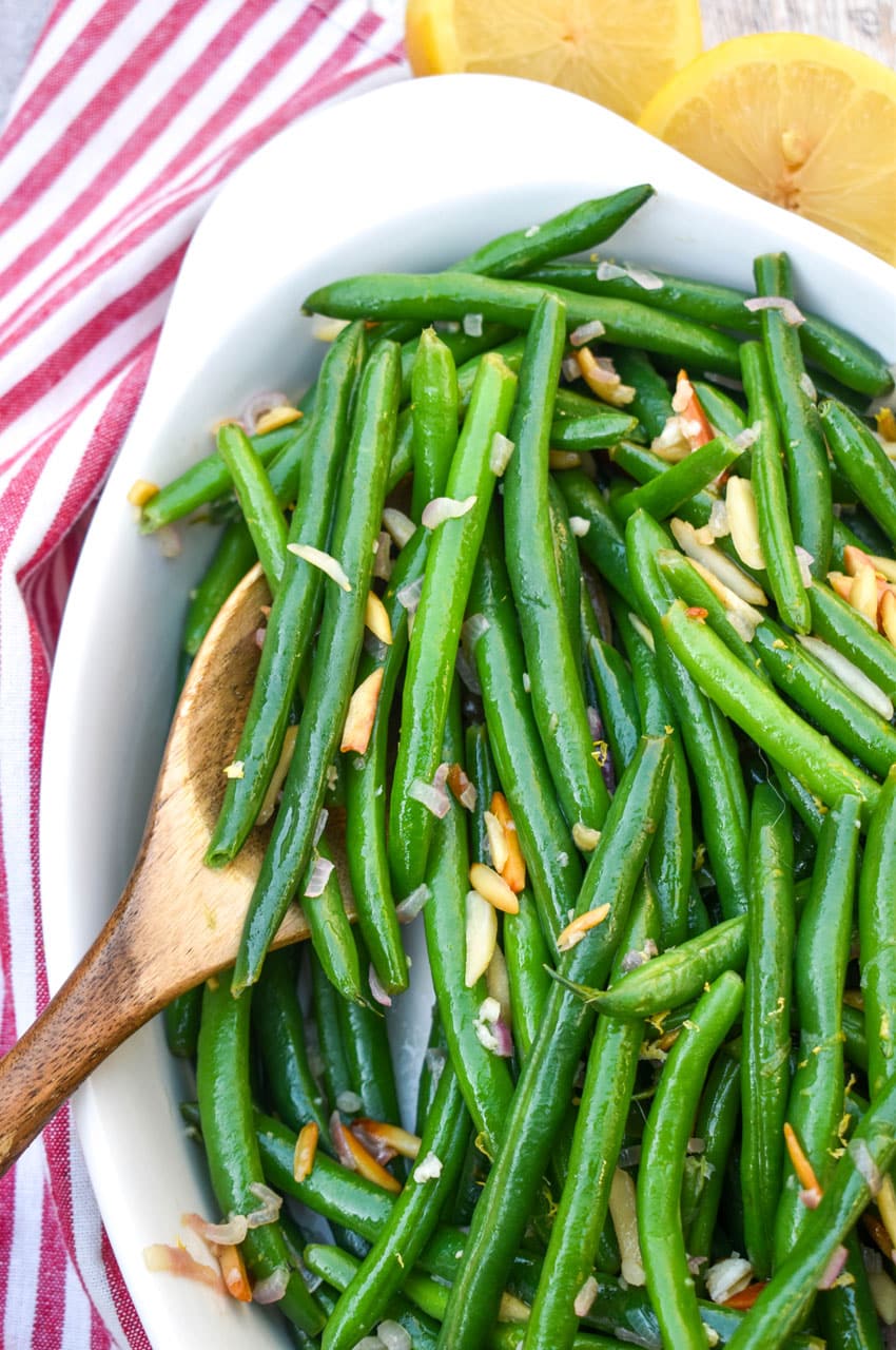 easy green bean almondine in a white serving dish