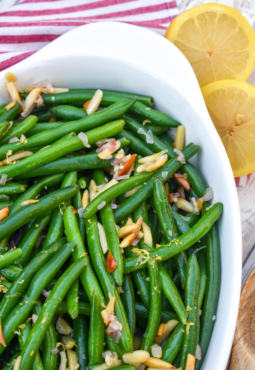easy green bean almondine in a white serving dish
