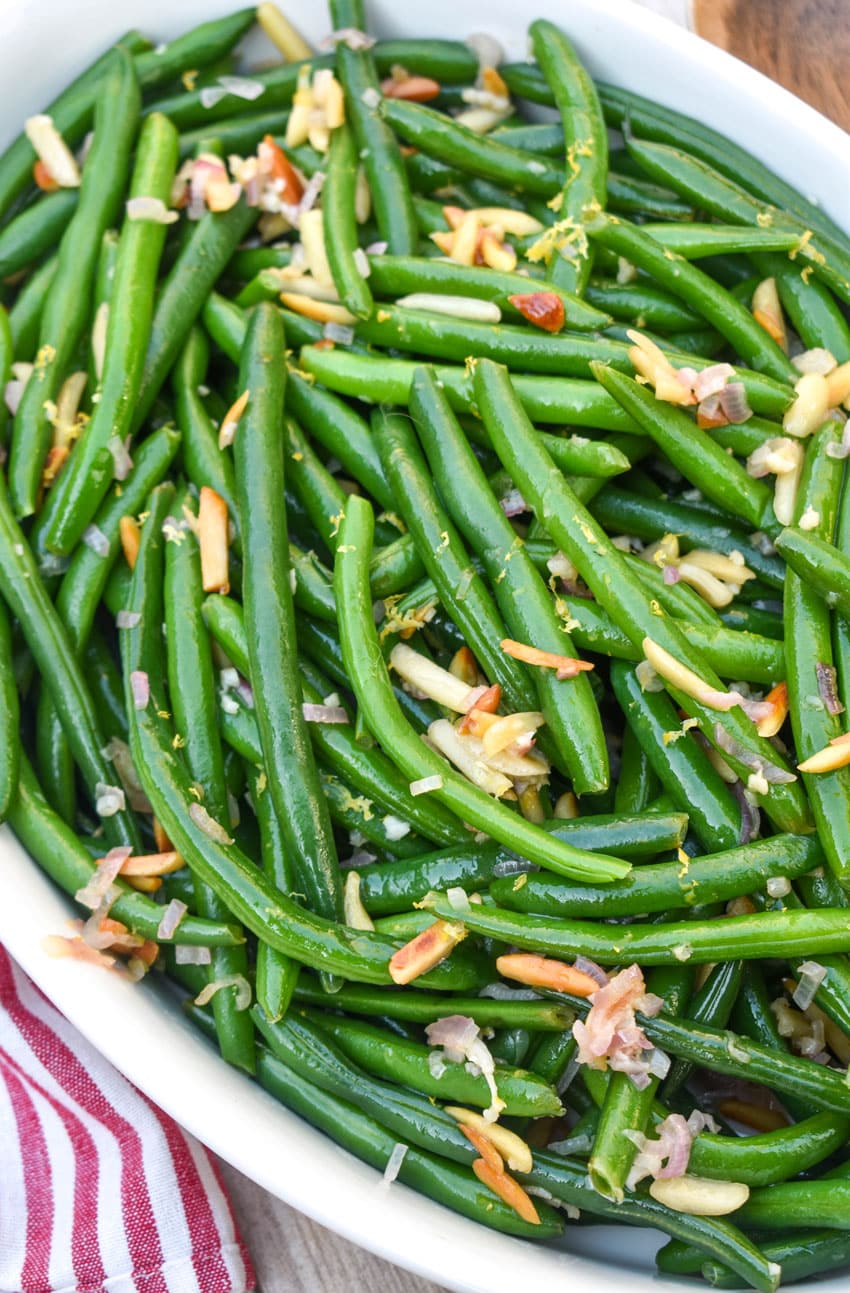 easy green bean almondine in a white serving dish