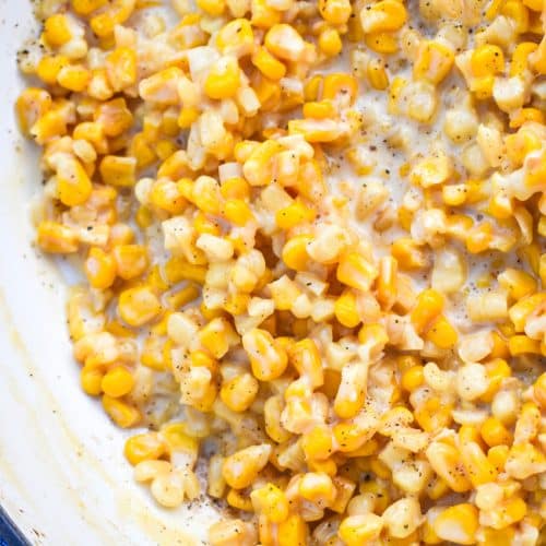 a close up of creamy honey butter skillet corn in a cast iron skillet