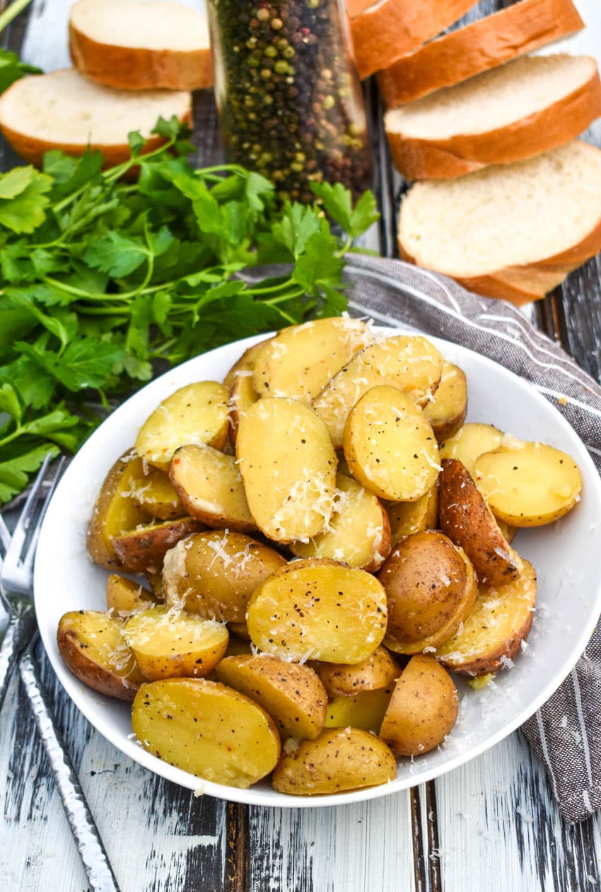 instant pot italian potatoes in a small white serving bowl
