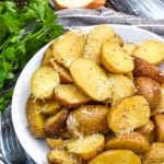 instant pot italian potatoes in a small white serving bowl