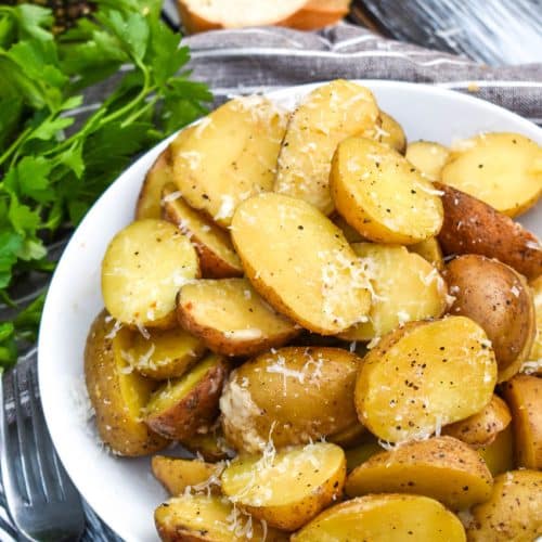 instant pot italian potatoes in a small white serving bowl