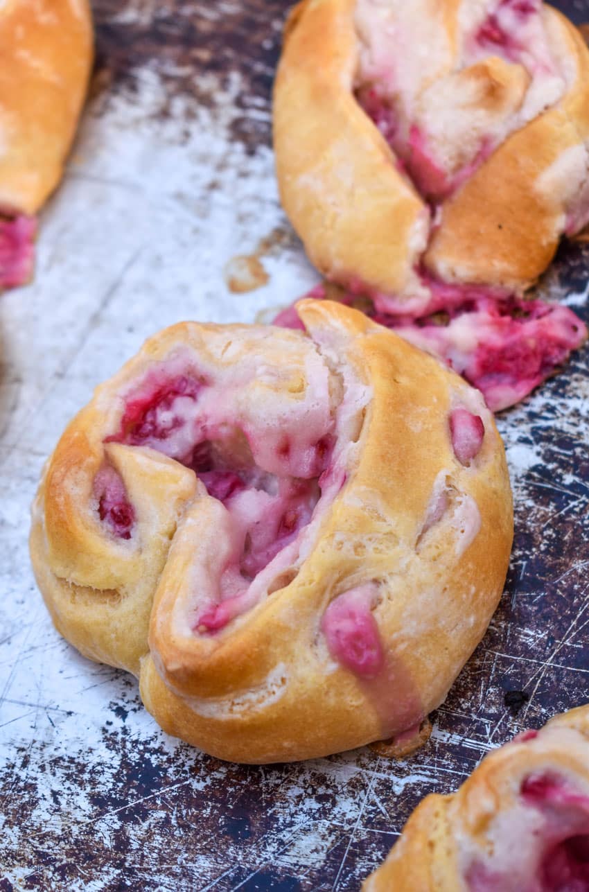 raspberry lemon danishes on a metal baking sheet
