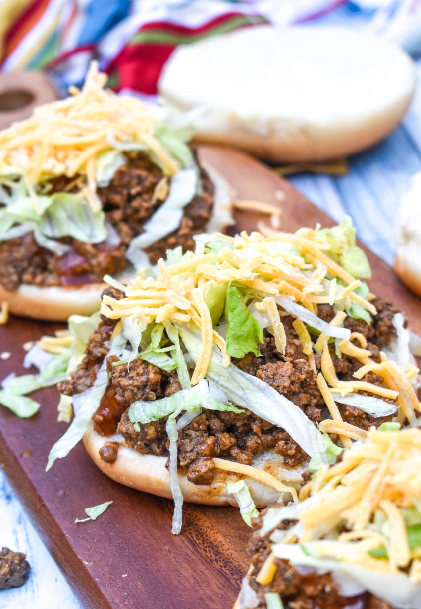 big bell beefer open faced sandwiches on a wooden cutting board