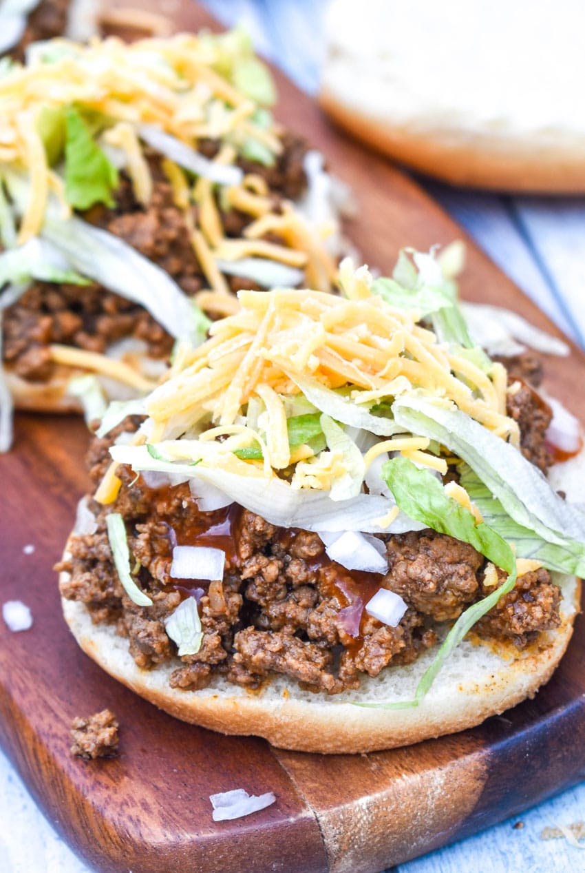 big bell beefer open faced sandwiches on a wooden cutting board
