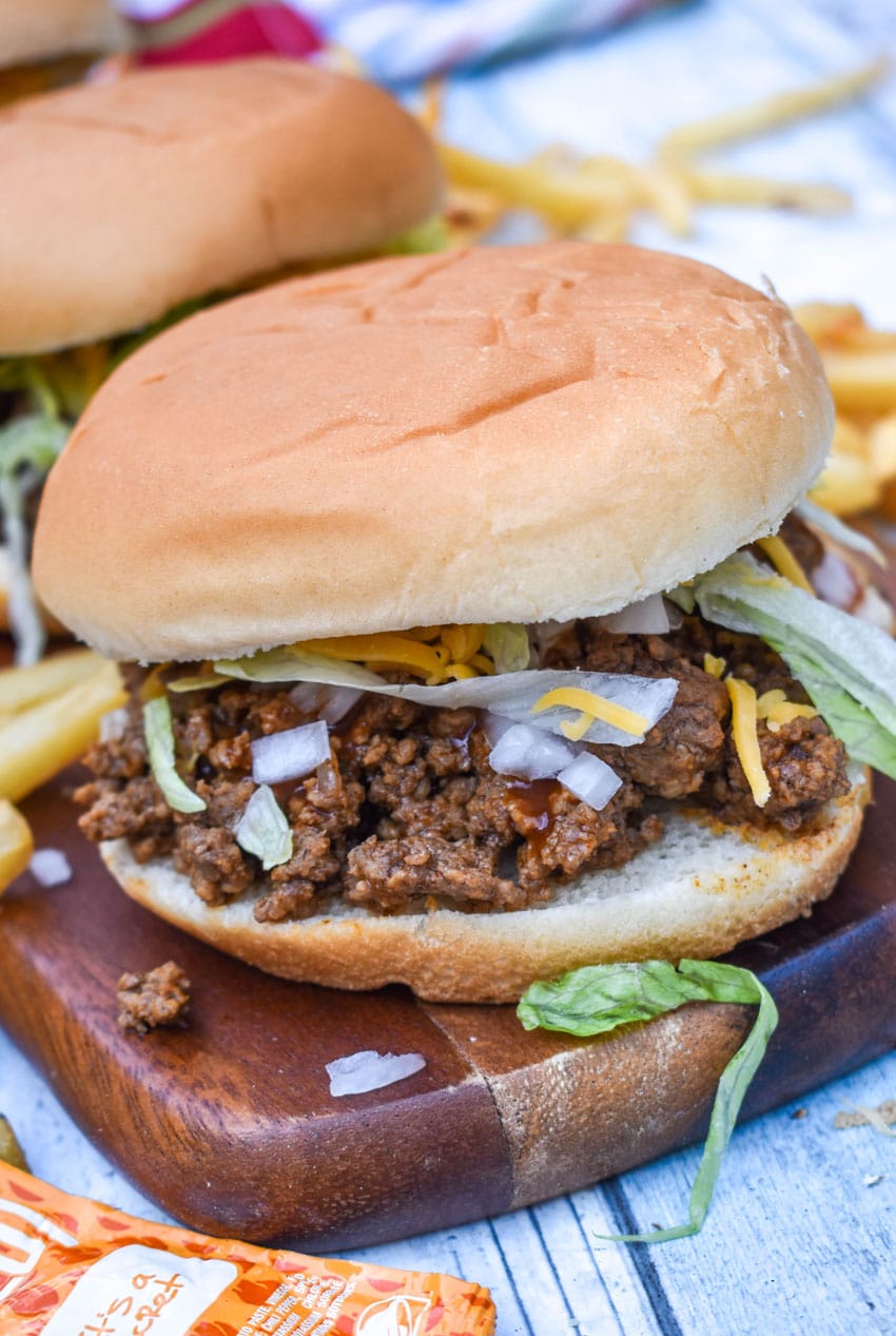 copycat taco bell big bell beefer sandwich on a wooden cutting board