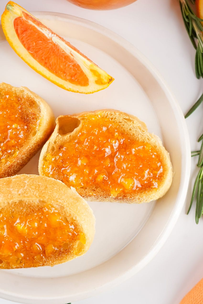 homemade orange marmalade spread on baguette slices