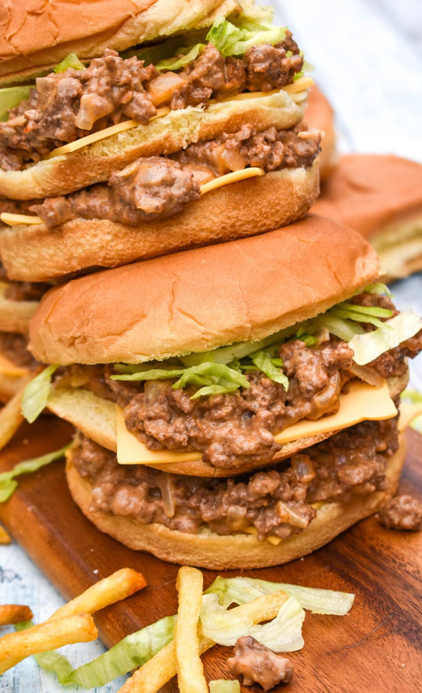 two big mac sloppy joes stacked on top of each other with crispy fries on the side