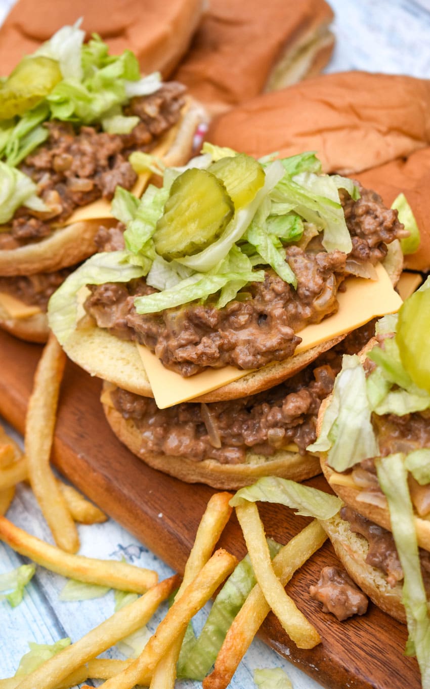 big mac sloppy joes being assembled on a wooden cutting board