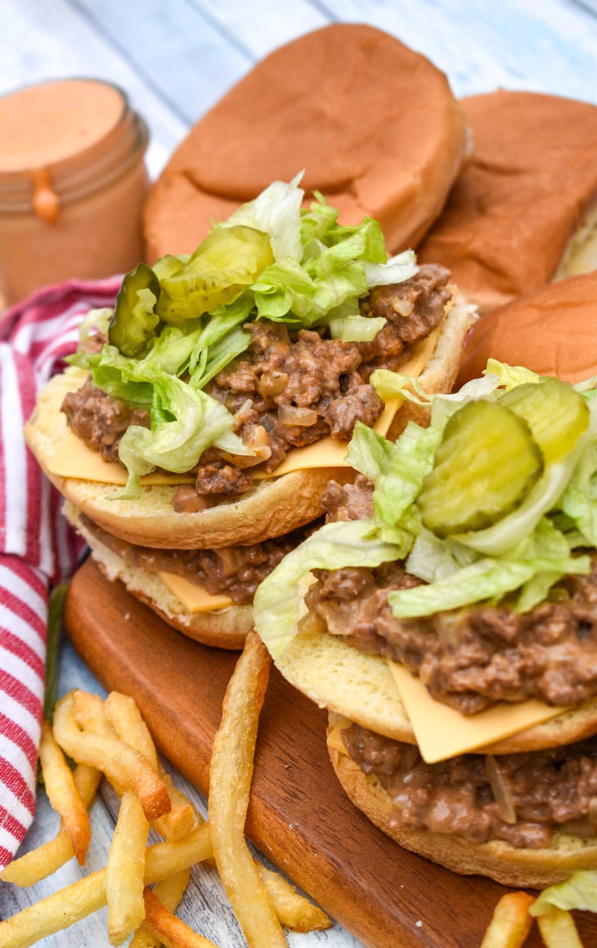 big mac sloppy joes being assembled on a wooden cutting board