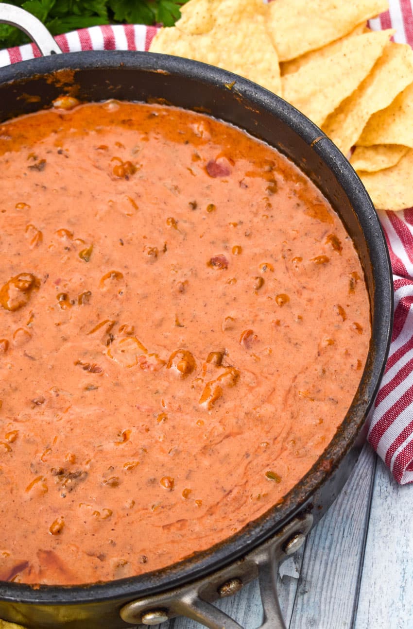 HOMEMADE CHILI CHEESE DIP IN A LARGE BLACK SKILLET