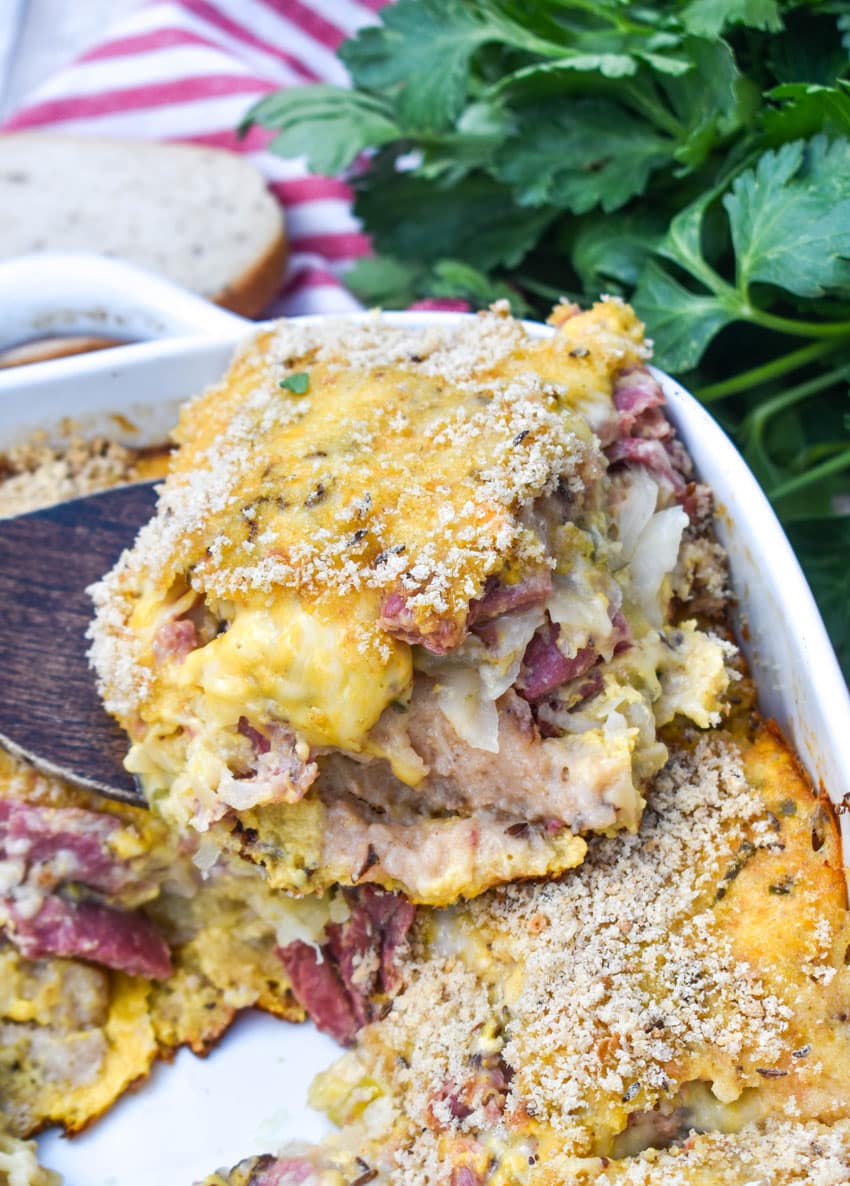 Easy Reuben Casserole a wooden spatula holding up a slice of reuben casserole