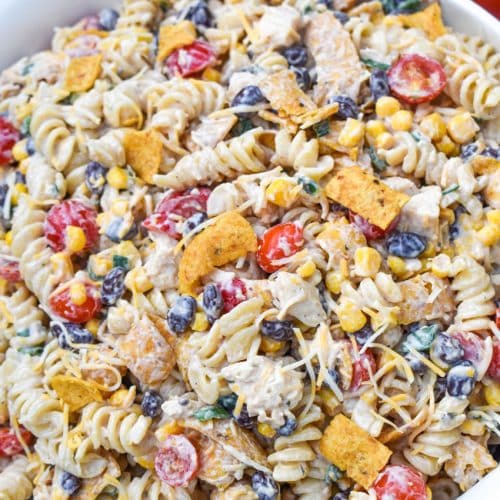 barbecue chicken pasta salad in a large white serving bowl