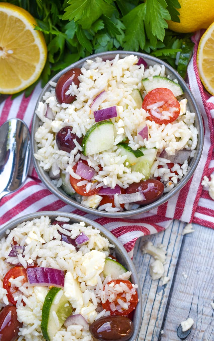 greek rice salad in two small gray bowls