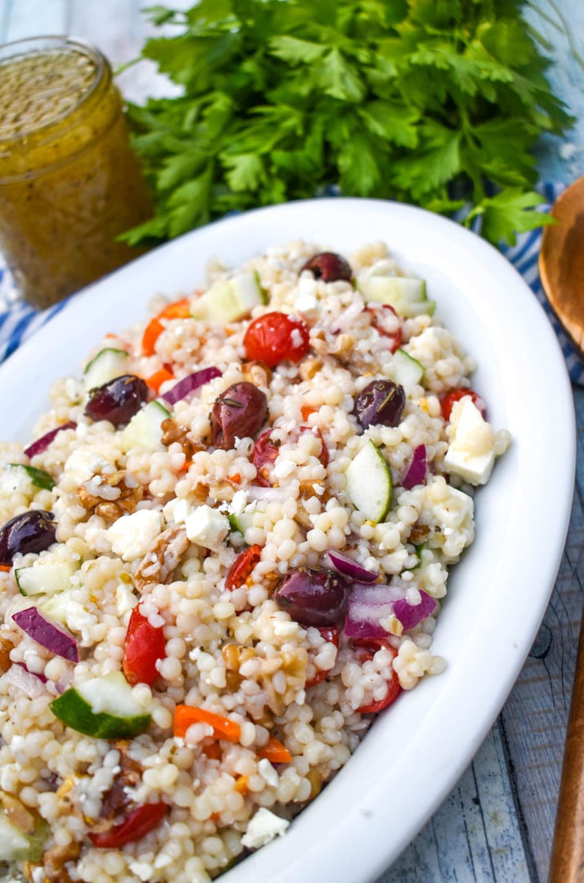 mediterranean couscous salad in a large white serving dish