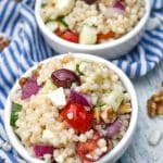 Mediterranean couscous salad in two small white bowls