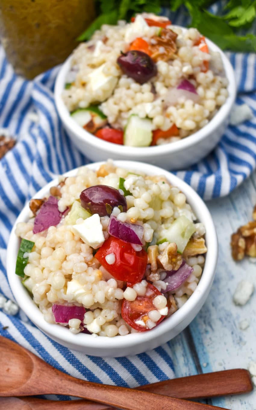 Mediterranean couscous salad in two small white bowls