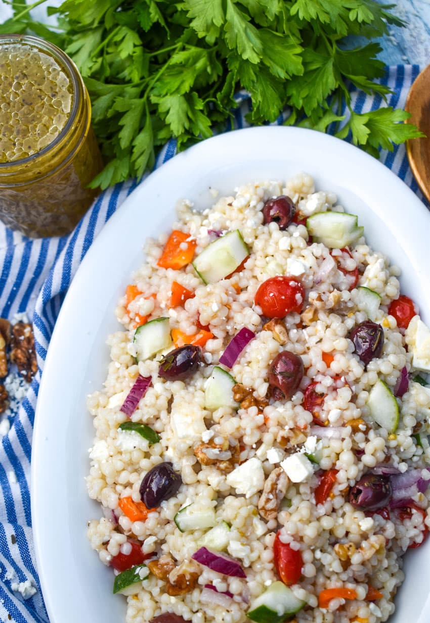 mediterranean couscous salad in a large white serving dish