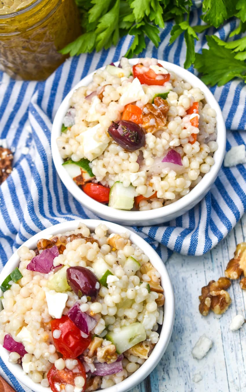 Mediterranean couscous salad in two small white bowls