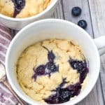 microwave blueberry muffin mug cakes in two white mugs