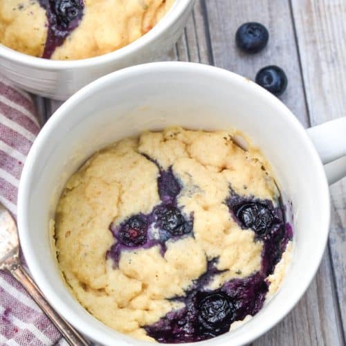 microwave blueberry muffin mug cakes in two white mugs