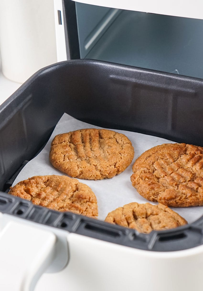 easy baked almond butter cookies in the basket of an air fryer