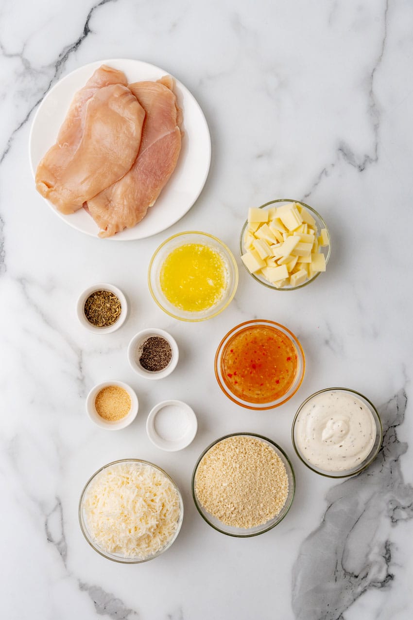 AN OVERHEAD IMAGE SHOWING THE MEASURED INGREDIENTS NEEDED TO MAKE LONGHORN STEAKHOUSE'S PARMESAN CRUSTED CHICKEN
