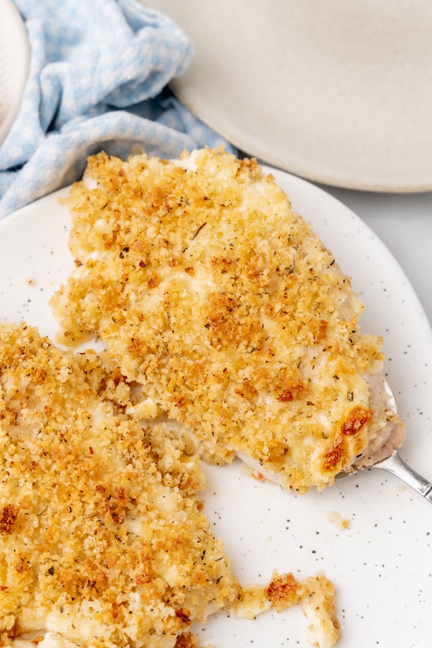 SLICES OF LONGHORN'S PARMESAN CRUSTED CHICKEN ON A WHITE SERVING PLATTER