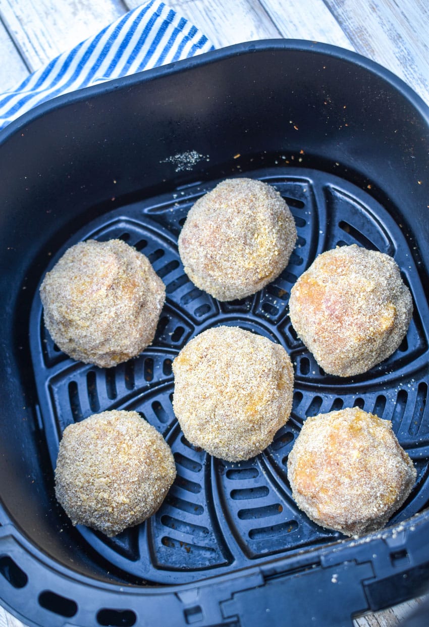 sausage balls in the basket of an air fryer