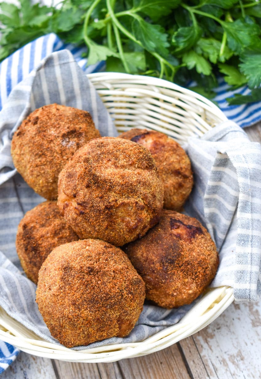 air fryer scotch eggs in a cloth lined straw basket
