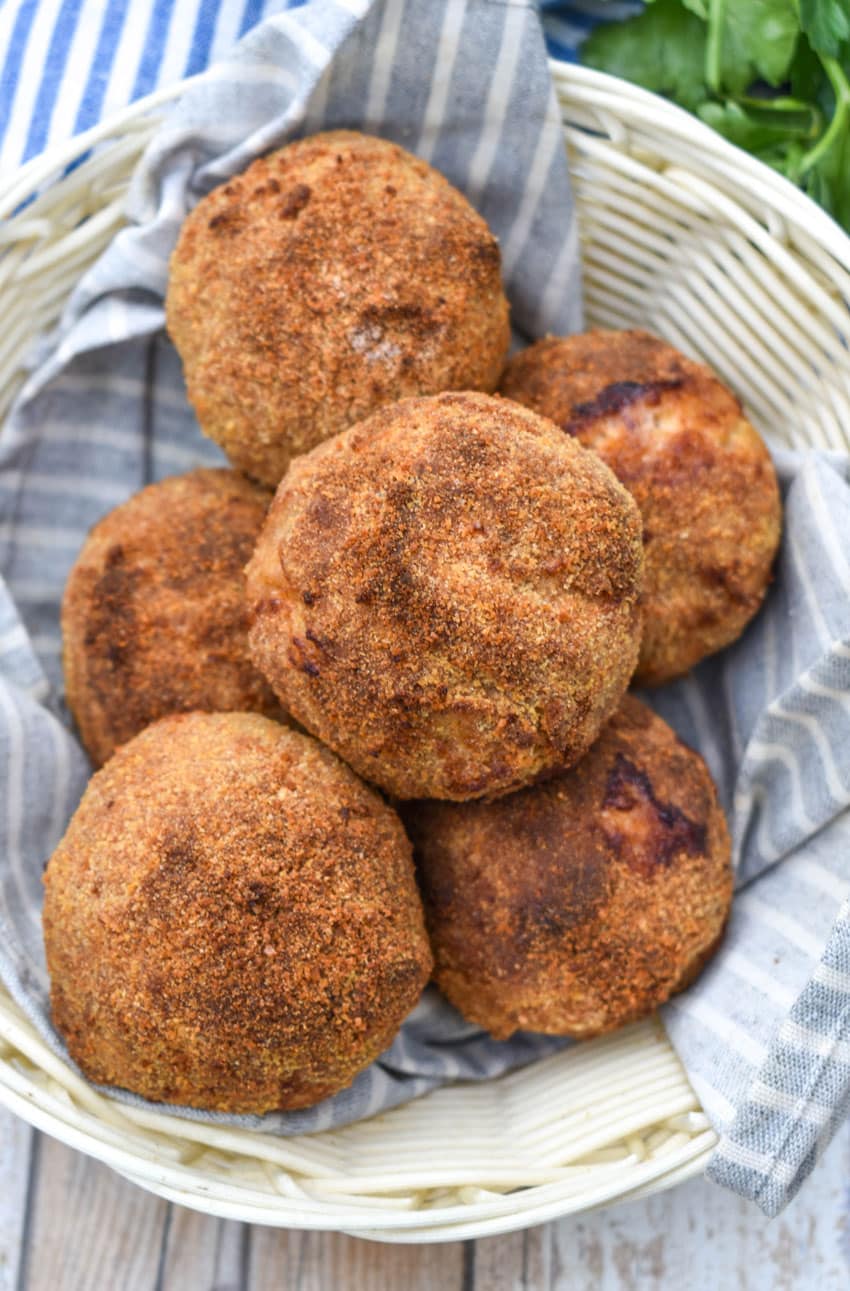 air fryer scotch eggs in a cloth lined straw basket