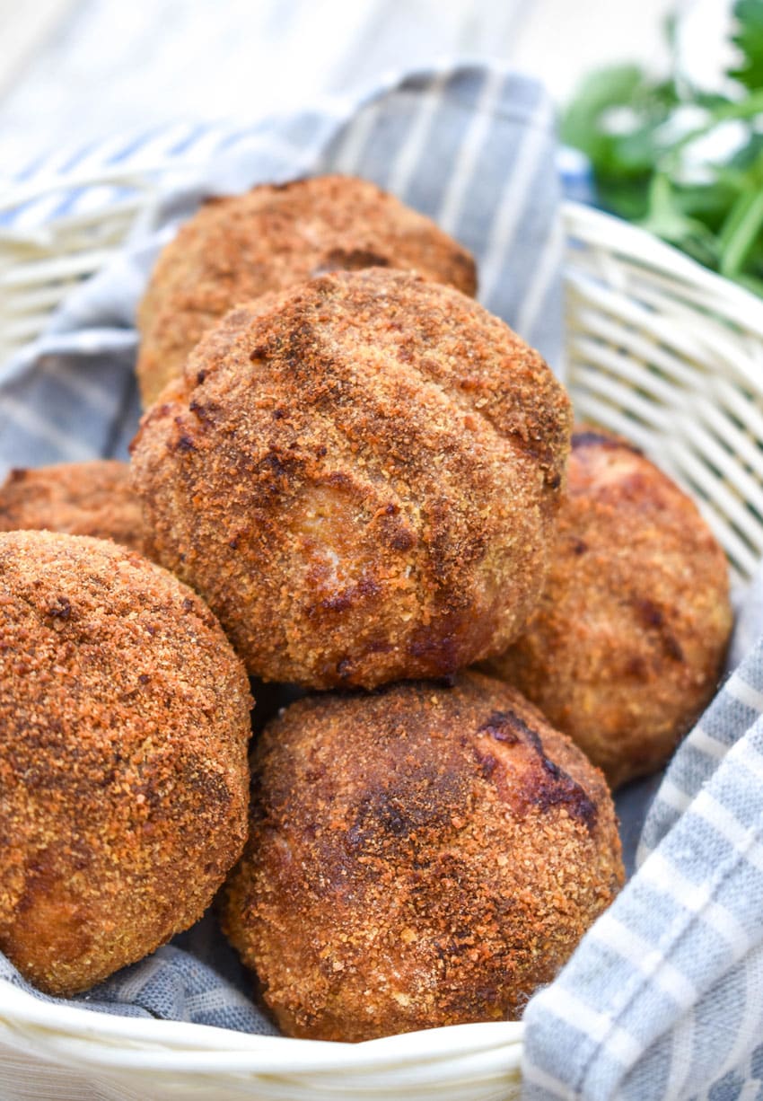 air fryer scotch eggs in a cloth lined straw basket
