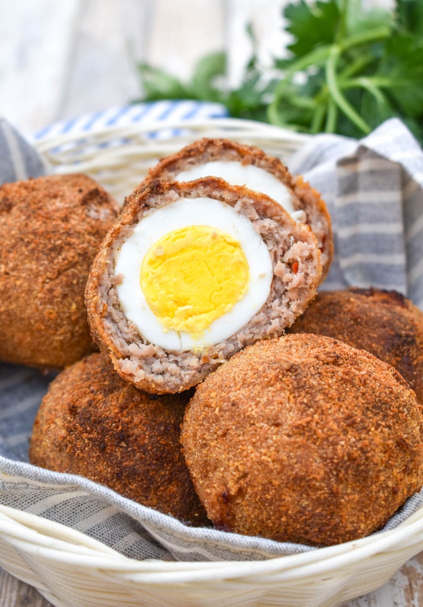 air fryer scotch eggs in a cloth lined straw basket