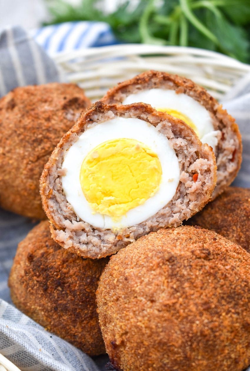 air fryer scotch eggs in a cloth lined straw basket