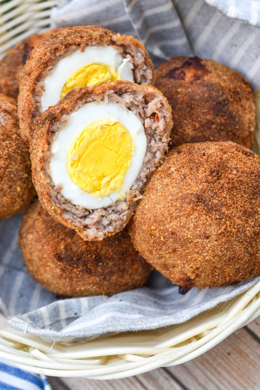 air fryer scotch eggs in a cloth lined straw basket