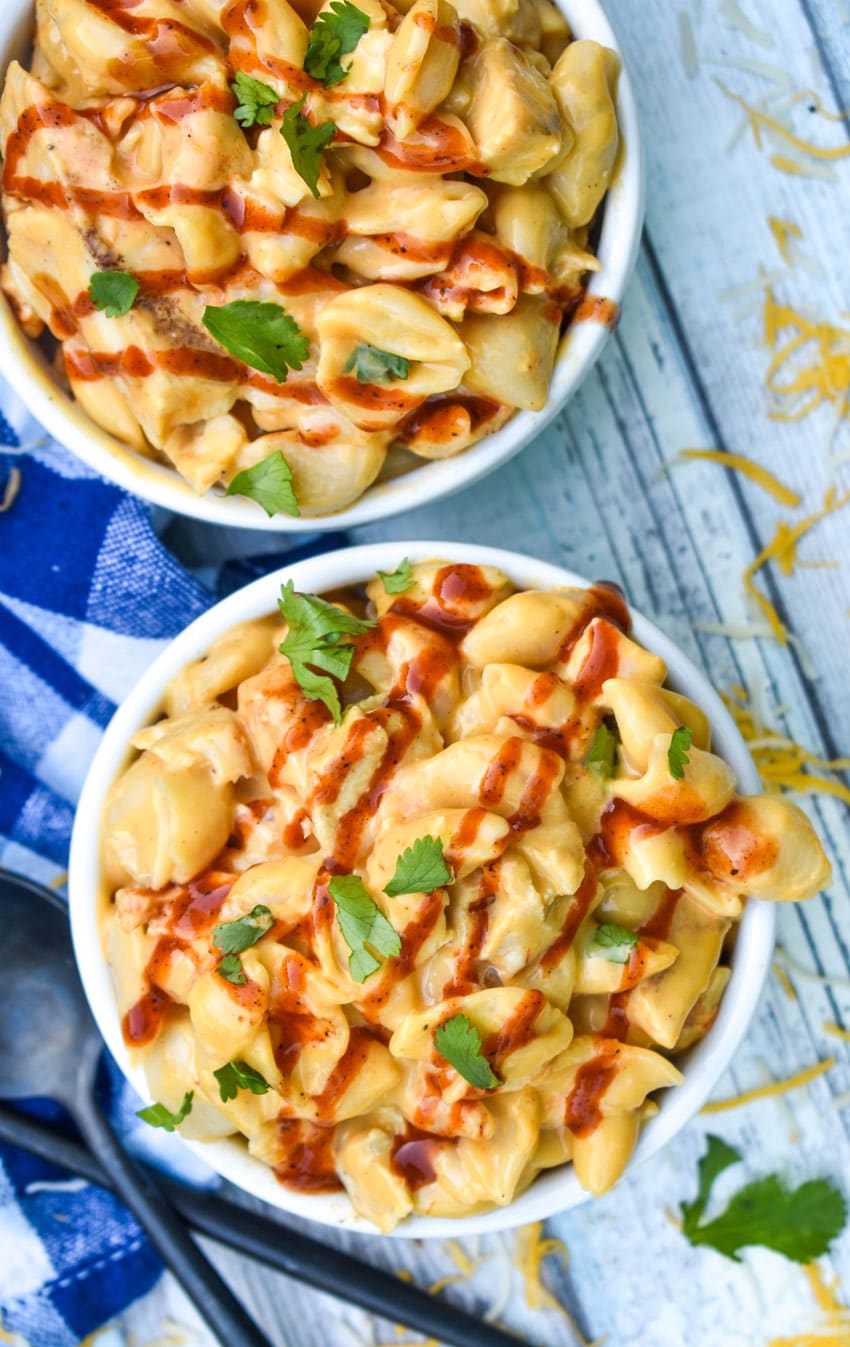 barbecue chicken mac and cheese in two small white ramekins