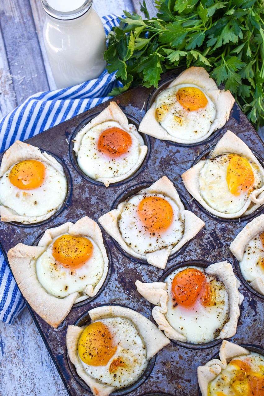 mini breakfast pie cups in the wells of a tin muffin pan
