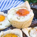 mini breakfast pie cups resting on the edge of a muffin tin pan