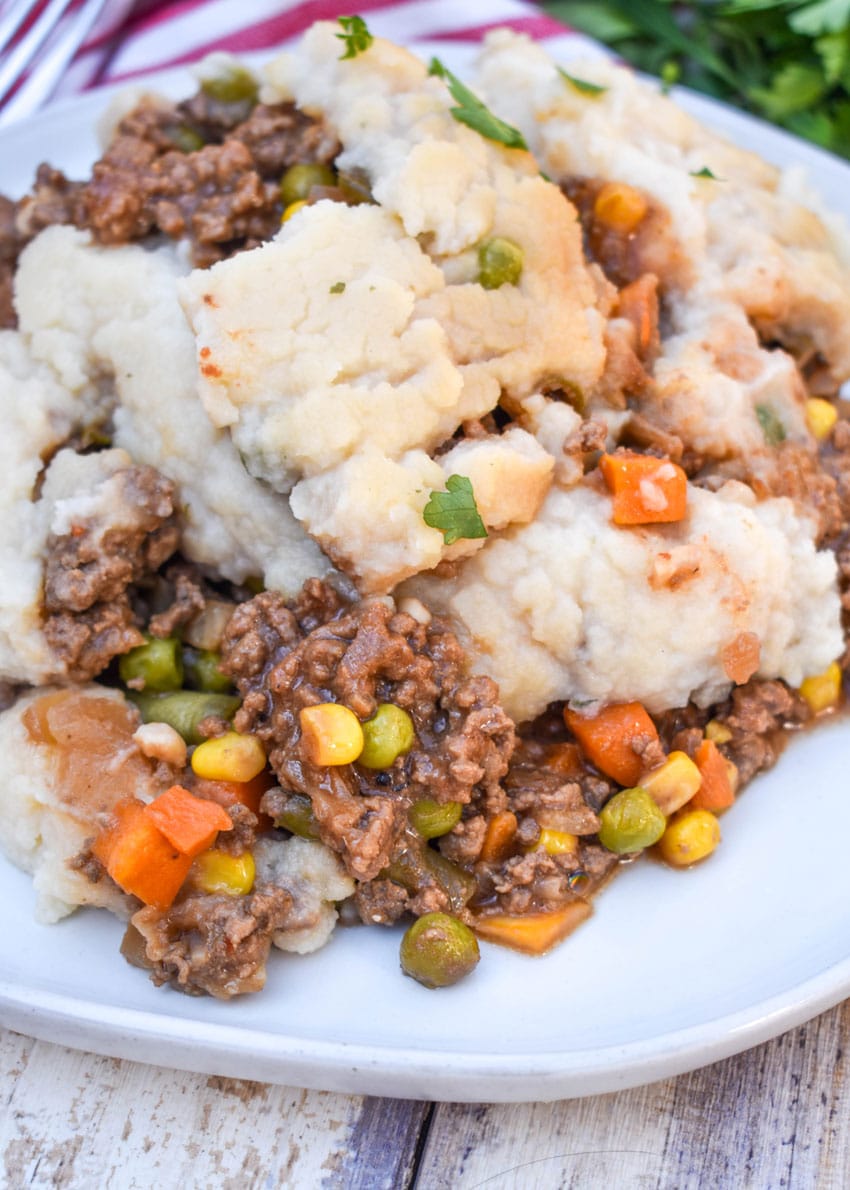 slow cooker shepherds pie served on a white dinner plate