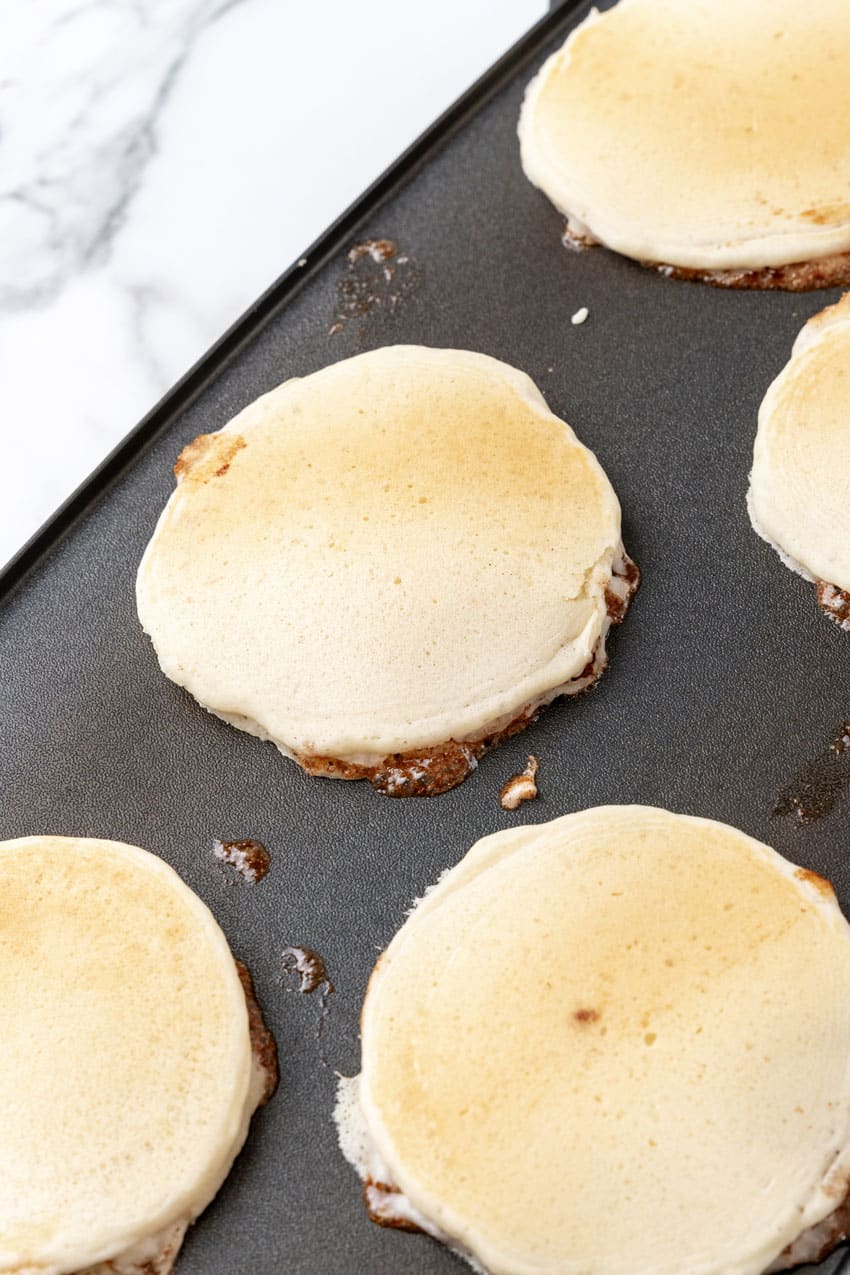 cooked cinnamon swirl pancakes on a hot griddle