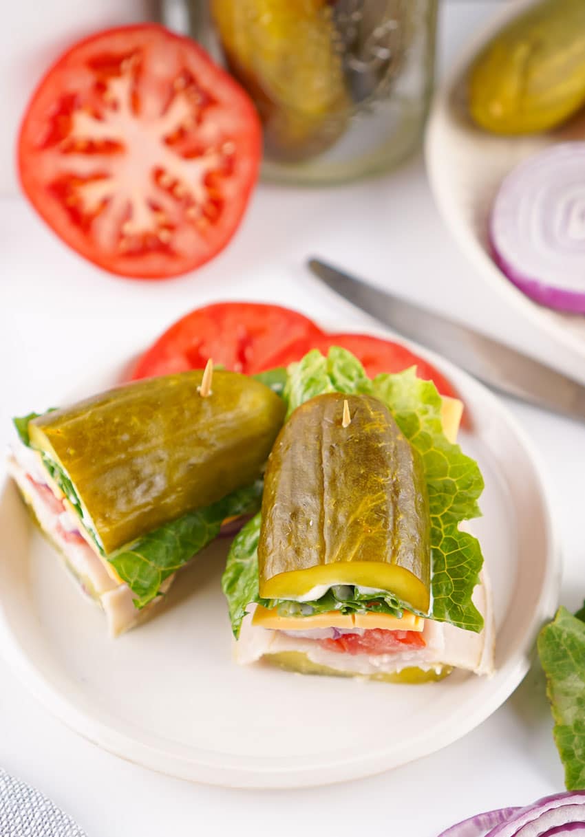 two halves of a picklewich sandwich on a white plate