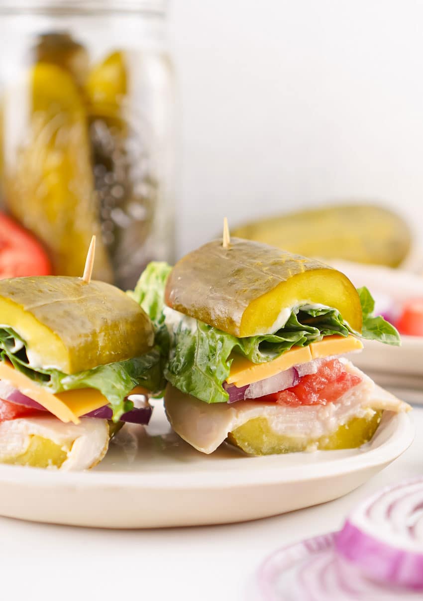 two halves of a picklewich sandwich on a white plate