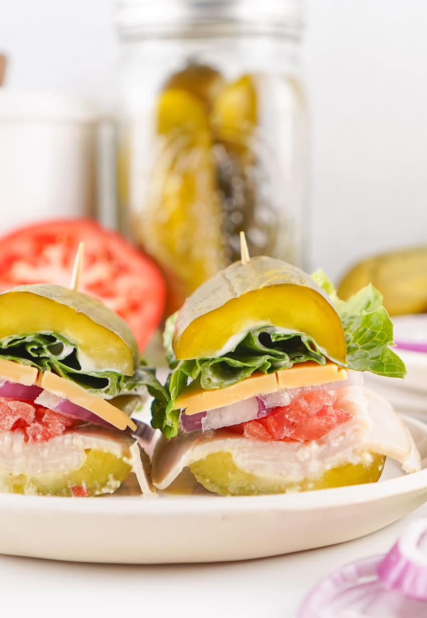 two halves of a picklewich sandwich on a white plate