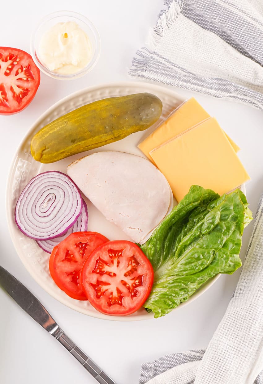 an overhead image showing the measured ingredients needed to make a jimmy john's copycat picklewich sandwich