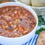 slow cooker beef and barley soup in a white bowl