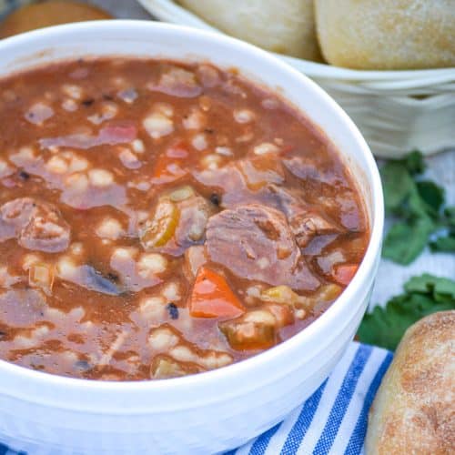 slow cooker beef and barley soup in a white bowl